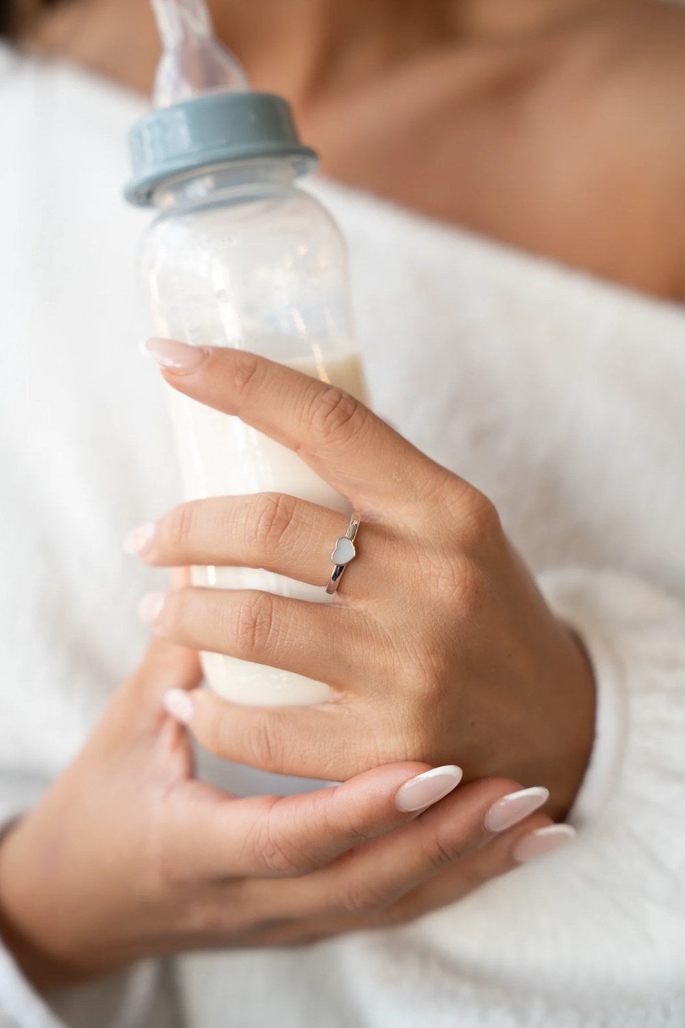 Vrouw draagt een moedermelksieraad van Mama Jewels